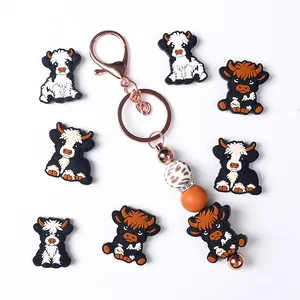 Handmade Highland Cow silicone bead keychain with leopard print and orange charms