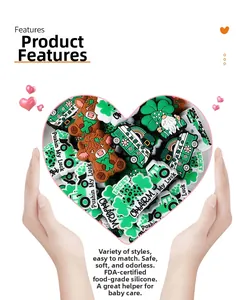 Close-up of heart-shaped hands holding St. Patrick's Day silicone beads and charms