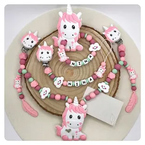 Customized baby pacifier chain with silicone beads and unicorn teething toy on wood