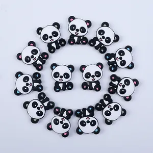 Flat lay of 13 cute panda silicone beads in black and white for DIY pacifier clips