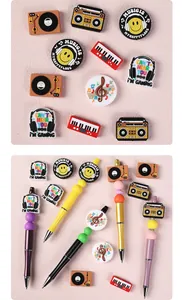 Detail showing musical theme PVC charms and beaded pens with radio and headphone designs