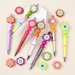 Colorful floral DIY beaded pens in seven bohemian styles on a white background
