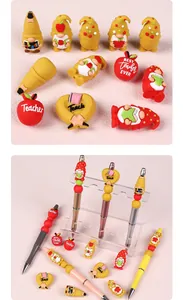 Detailed close-up of teacher-themed 3D silicone beads and DIY beaded pens on a display stand