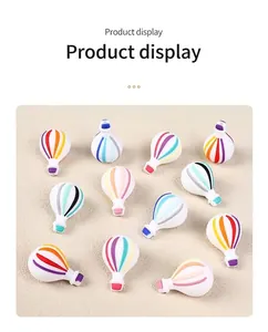 Detail view of 3D hot air balloon silicone beads with colorful striped patterns for DIY