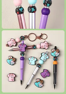 Detailed view of DIY medical themed beaded pens with silicone scrubs and stethoscope charms