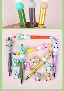 Close-up of DIY beaded ballpoint pens with cute 3D silicone koala charms and colorful beads
