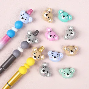 Cartoon koala silicone beads with colorful DIY beaded pens on a pink background