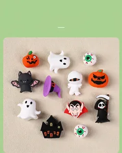 Flat lay of 12 Halloween silicone charms including pumpkins, ghosts and bats for DIY crafts