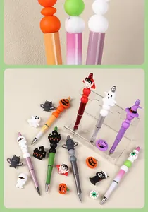 DIY Halloween beaded pens with cartoon pumpkin ghost and bat charms on acrylic stands