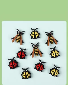 Detailed flat lay of 3D cartoon ladybug and bee silicone beads for DIY jewelry making