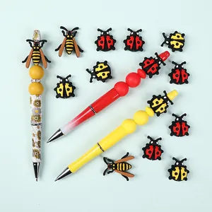 DIY beaded pen set with insect silicone beads featuring ladybugs and bees on colorful pens