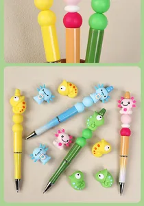Detail of colorful 3D silicone chameleon and axolotl beads on custom beaded pens