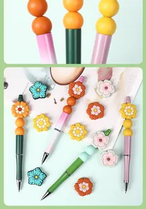 Detail of colorful flower silicone beads on creative DIY beaded pens with pastel colors
