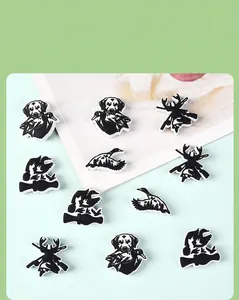 Detail view of hunting themed black and white silicone shoe charms with dog and deer patterns