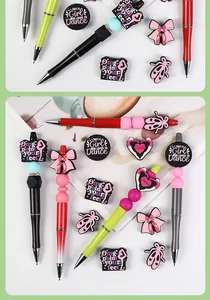 Detail of beaded ballet-themed pens with soft rubber ballet shoes and bow charms