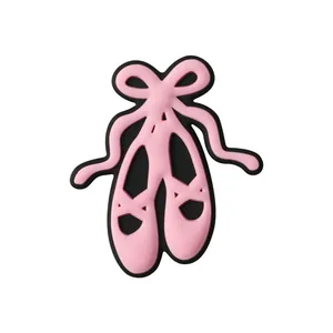Pink ballet shoe charm for clogs with bow detail and black base on white background