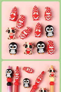 Detailed view of heart penguin and cow silicone beads mounted on colorful beaded pens