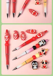 Detail view of cartoon 3D silicone beads on pens featuring cow and gnome characters