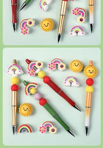 Detail of colorful 3D silicone rainbow and cloud beads on creative metal ballpoint pens