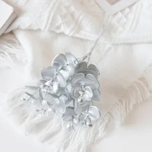 Macro detail of artificial eucalyptus leaves with elegant silver metallic coating