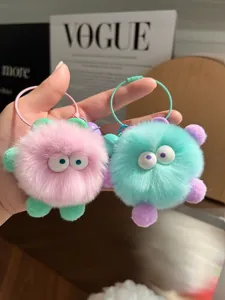 Detailed macro view of soft pink and cyan plush keychains with colorful wire rings