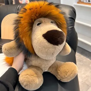 Close-up of a 45cm plush lion doll with thick fur texture on a black leather sofa