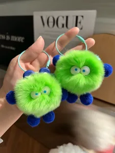 Close-up of neon green plush monster keychain charms with mint green steel wire rings