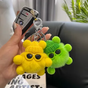 Cute plush keychain set with fuzzy pom poms wearing mini hats and sunglasses