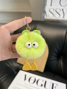 Close-up of fluffy neon green monster plush keychain with soft fur and gold metal ring