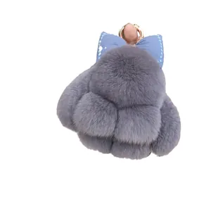 Cute grey faux fur bunny keychain with blue glitter bow and gold metal ring