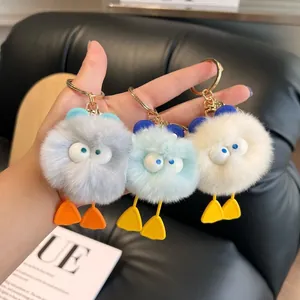 Plush monster duck keychains with fluffy faux fur and golden hardware in various colors