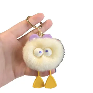 Cute beige plush duck keychain with large purple eyes and gold metal ring for bags