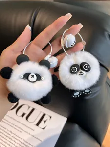 Close-up of cute fluffy panda plush keychains with bells and woven straps on bags