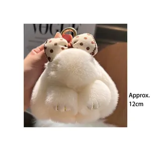 Detailed view of a 12cm white plush bunny keychain with a brown polka dot bow and ring