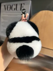 Close-up of a fluffy panda bag charm made of soft rex rabbit fur with black metal clip