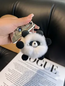 Close-up of a soft panda plush keychain with fluffy white fur and pearl eye accents