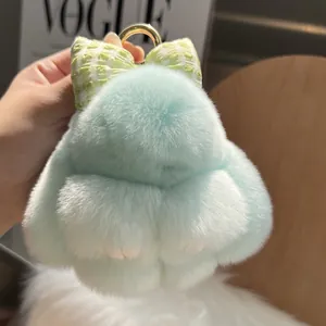 Mint green plush rabbit keychain with a checkered bow and golden metal clip attachment