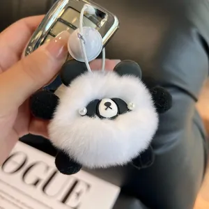 Panda faux rabbit fur plush keychain with pearl eyes and bell on leather background
