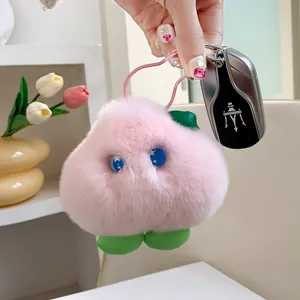 Close-up of pink plush heart-shaped keychain accessory on a soft velvet-like fabric