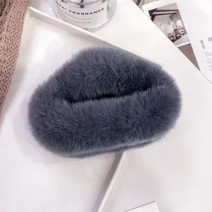 Detailed view of dark grey plush faux fur hair claw clip in a warm home lifestyle setting