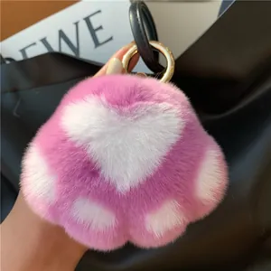 Close-up of heart-shaped rabbit fur keychain with pink and white plush texture