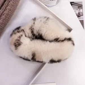 Detailed view of plush leopard print faux fur hair claw clip on a minimalist tray
