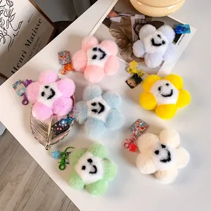 Dettaglio di portachiavi in peluche a forma di fiore sorridente in vari colori vivaci