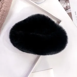 Close-up of black faux fur fluffy hat material on a minimalist lifestyle background