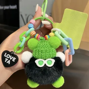 Neon green plush monster keychain with sunglasses and a black Love Ya heart charm