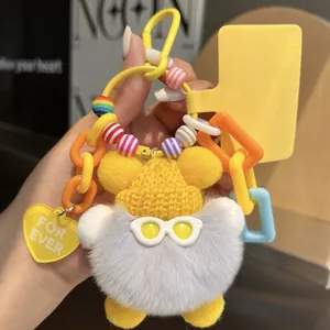 Detail of plush bear keychain with yellow knit hat, glasses, and colorful bead charm