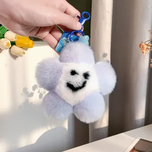 Portachiavi a fiore in peluche viola con faccina sorridente e ciondolo a stella blu