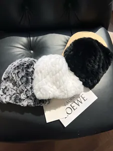 Detailed texture of thick rabbit fur beanies in black, white and leopard pattern