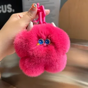 Portachiavi mostro fiore in peluche fucsia con occhi a cuore blu e catena in plastica