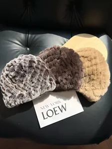 Detailed plush texture of winter faux rabbit fur hats in black, brown and beige shades